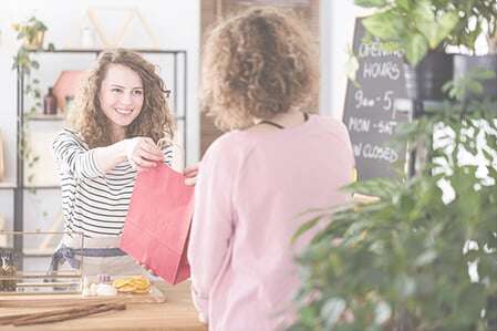 Lady handing bag in health store