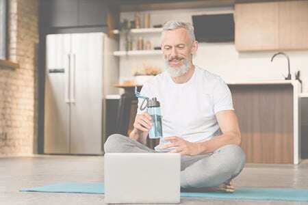 Old fitness guy using laptop